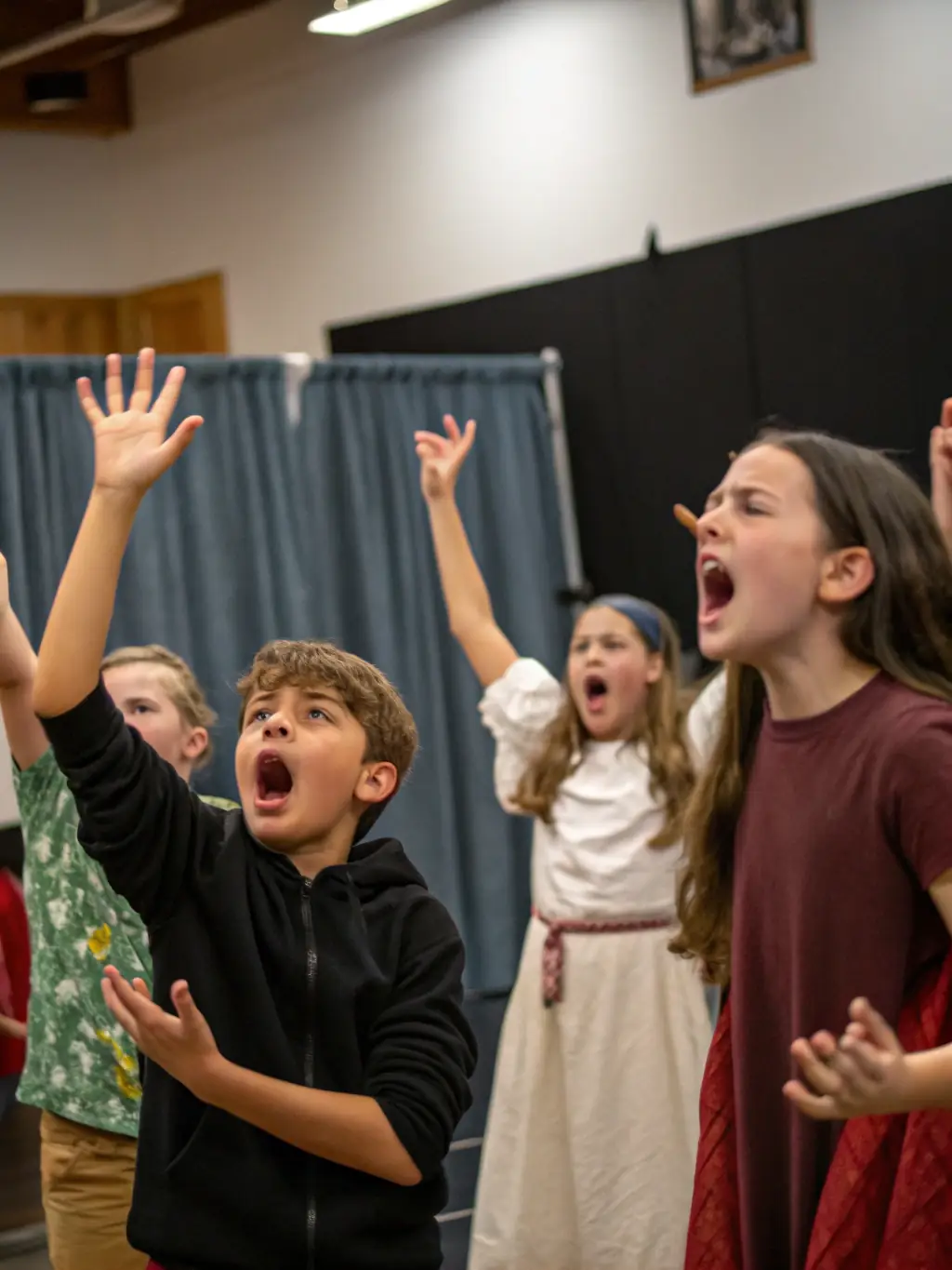 Teenagers collaborating on a scene during a theater workshop, showcasing teamwork and creative expression.