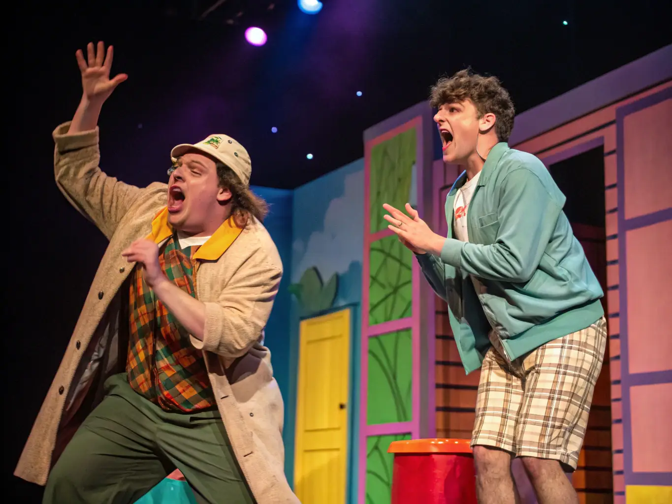 A vibrant photograph capturing a scene from one of La Pirouette Théâtre's comedy productions, showcasing actors in colorful costumes delivering a humorous performance on stage, with the audience visibly enjoying the show.